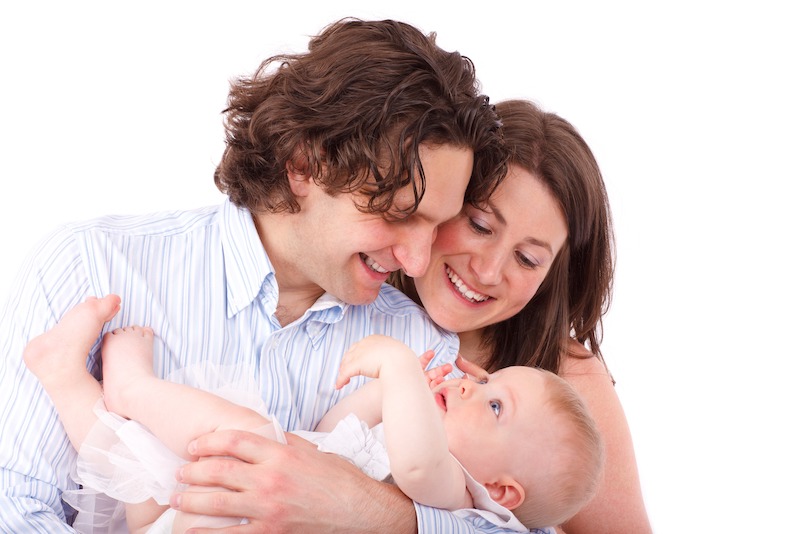 parents holding baby